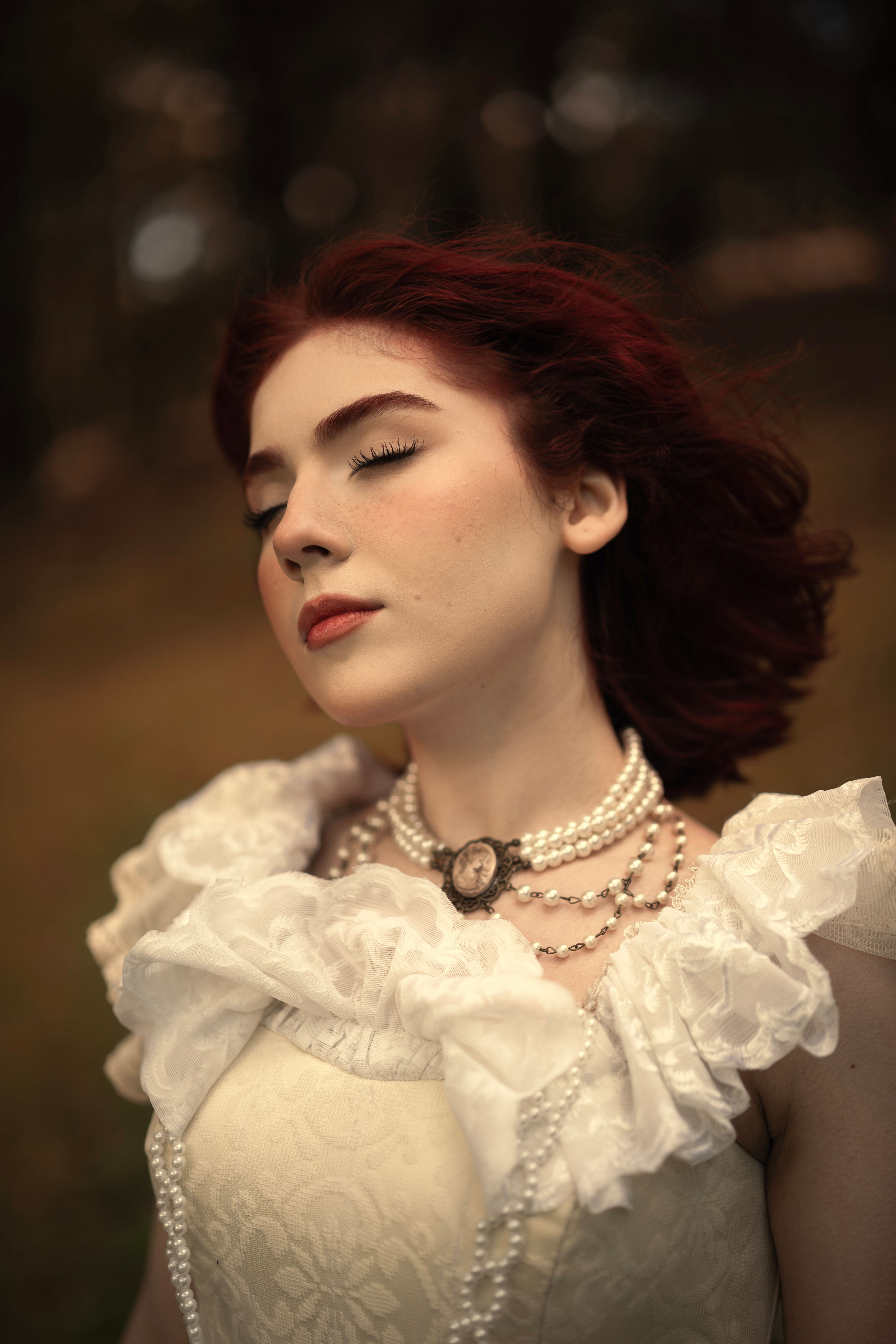 Elegant portrait of a woman with red hair in Victorian attire outdoors.. elegant, portrait, woman