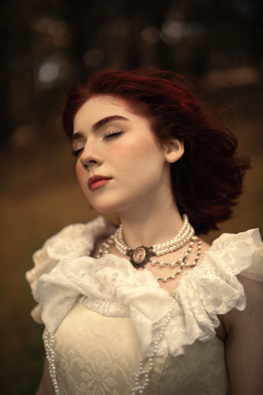 Elegant portrait of a woman with red hair in Victorian attire outdoors.. elegant, portrait, woman