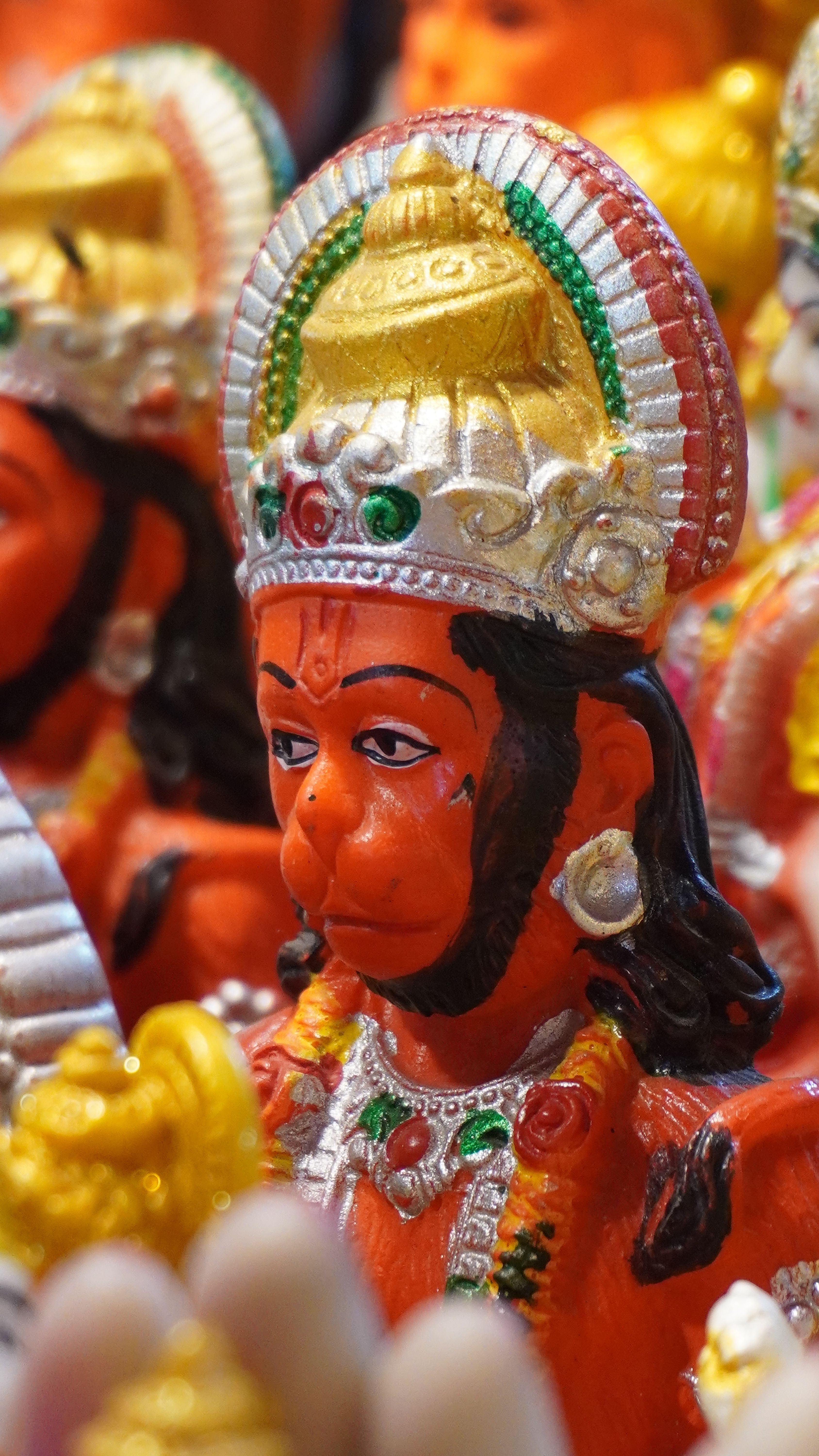 Colorful Hanuman idol at a market stall in Sonepur, Bihar, India, depicting Hindu mythology.