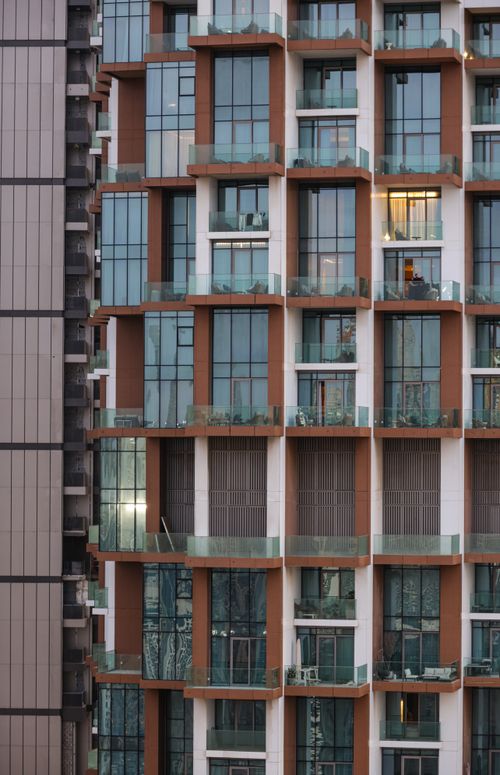 Free Close-up view of a modern high-rise building facade with glass balconies showcasing urban architecture. Stock Photo