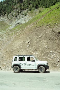 4x4 adventure vehicle on a scenic mountain road near Sonamarg, perfect for nature and adventure enthusiasts.