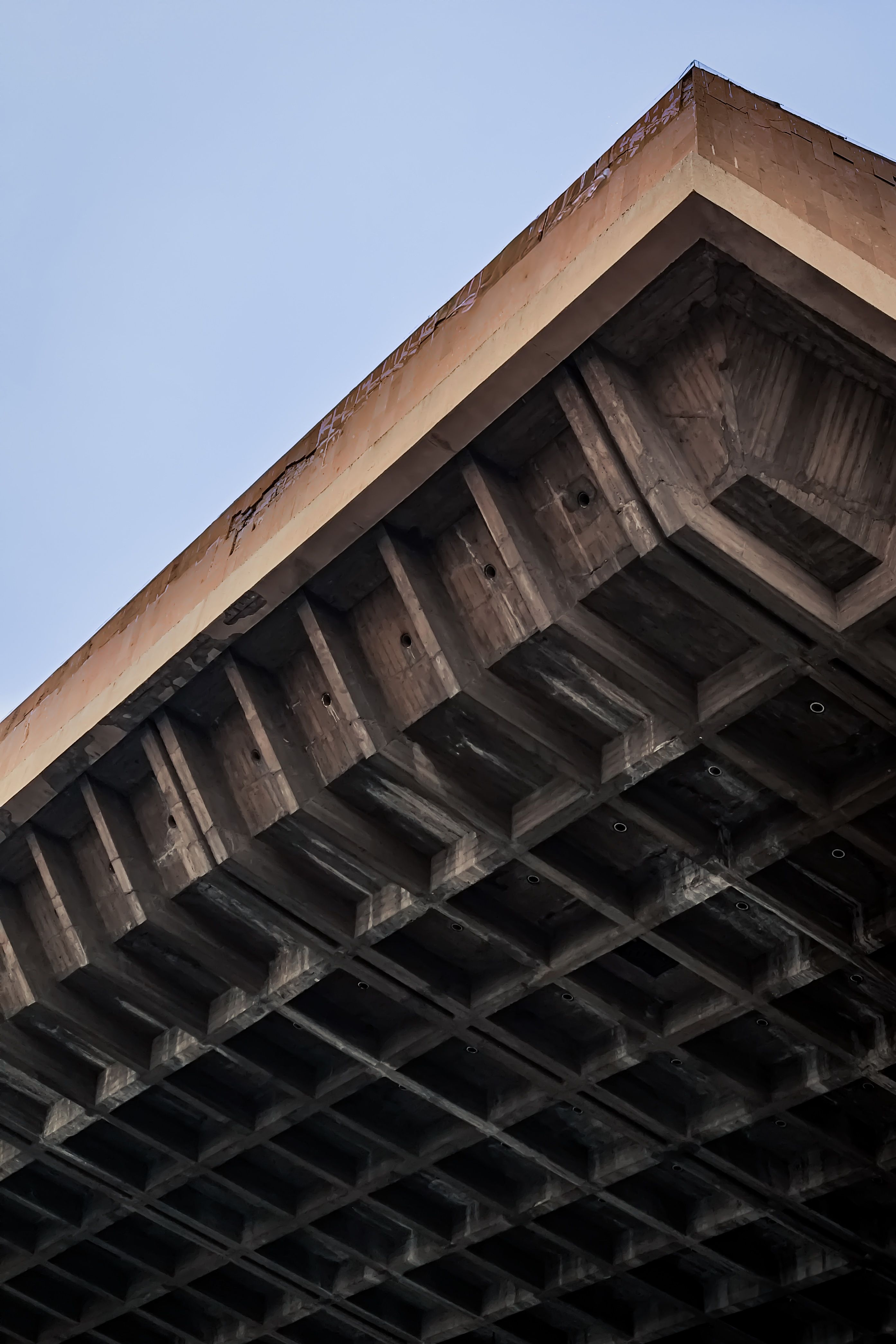 Low angle view of a brutalist concrete structure with a geometric pattern in Yerevan, Armenia.. angle, view, brutalist