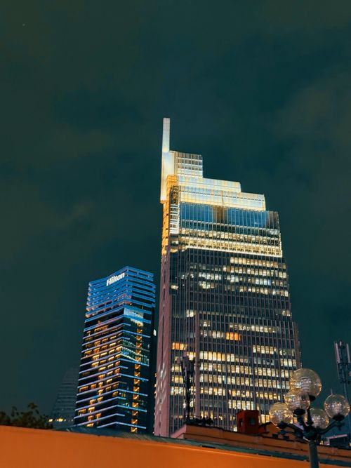 Free Beautiful cityscape view of illuminated skyscrapers against a dark night sky. Stock Photo