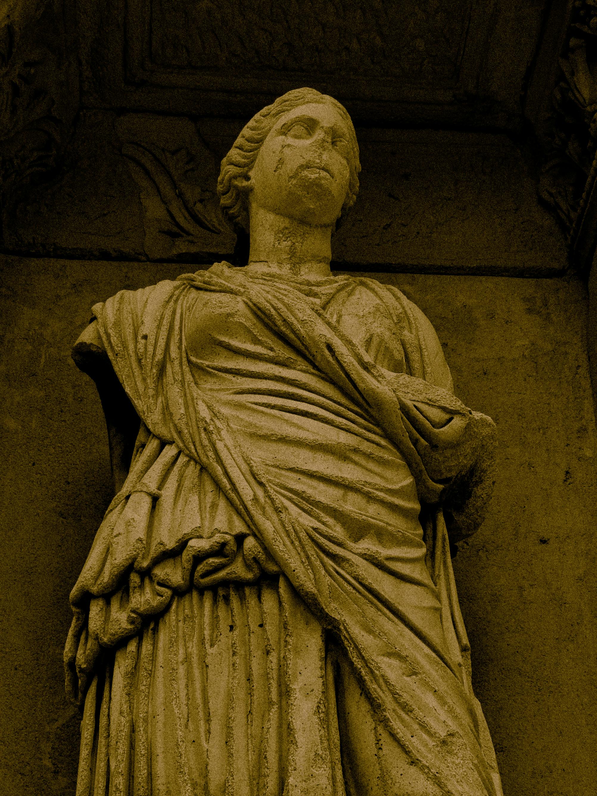 Close-up of an ancient statue with architectural details in İzmir, Türkiye.