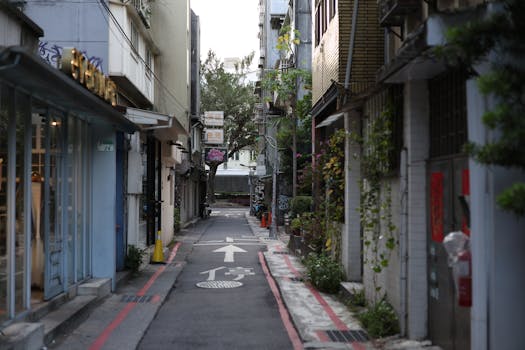 Explore a serene alleyway in Taipei, Taiwan, showcasing vibrant urban architecture and greenery.