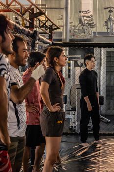Group of diverse adults in a mixed martial arts training session at a gym in San Luis Potosí.