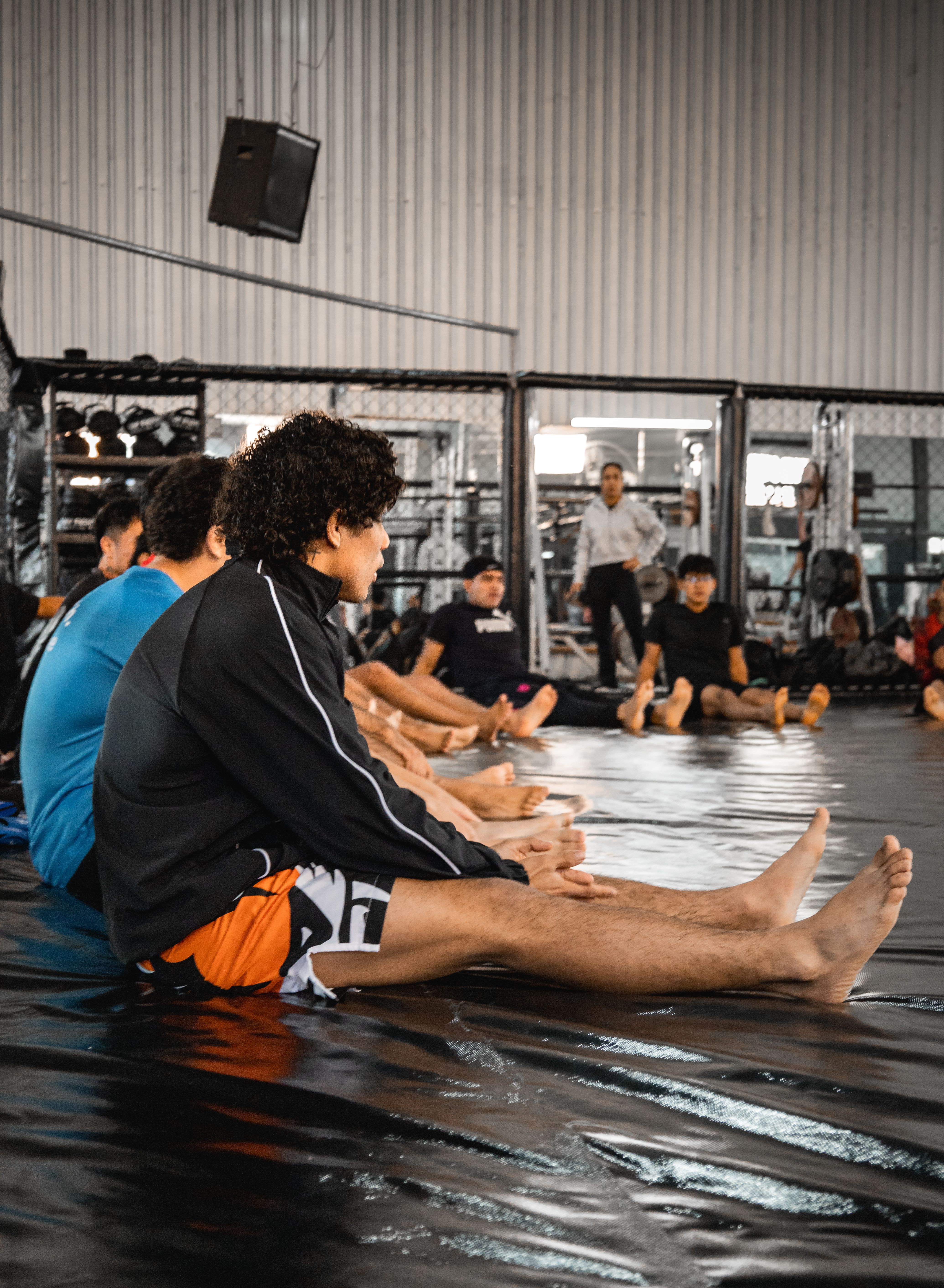 A full martial arts class training together, led by an instructor