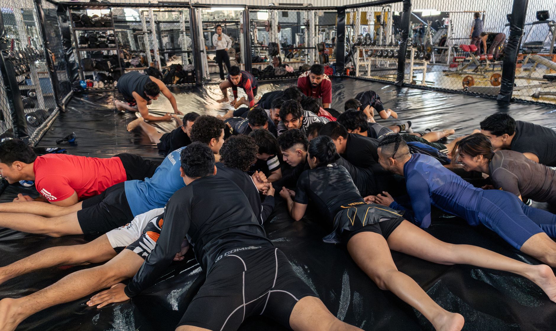 Group of athletes practicing martial arts indoors in San Luis Potosí, Mexico gym.