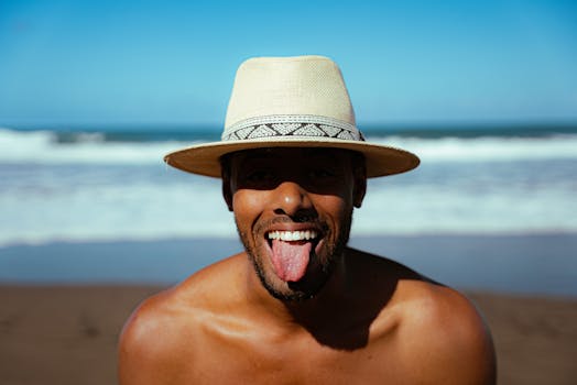 Man enjoying a sunny day at a beach in the Canary Islands, playfully sticking out his tongue.
