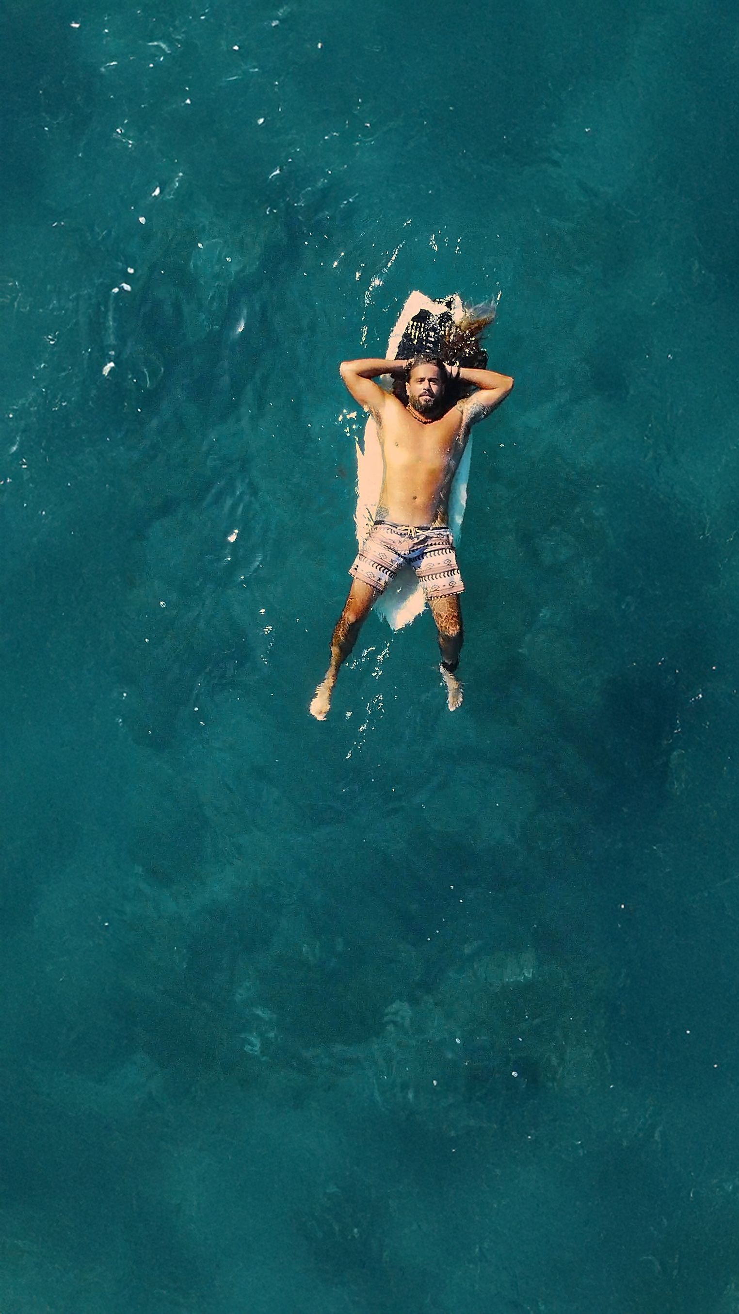 Relaxed Man Floating in Clear Ocean Waters · Free Stock Photo