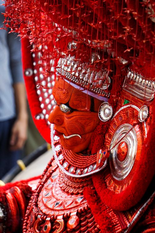 Free Close-up of a Theyyam performer in intricate traditional costume and makeup. Stock Photo