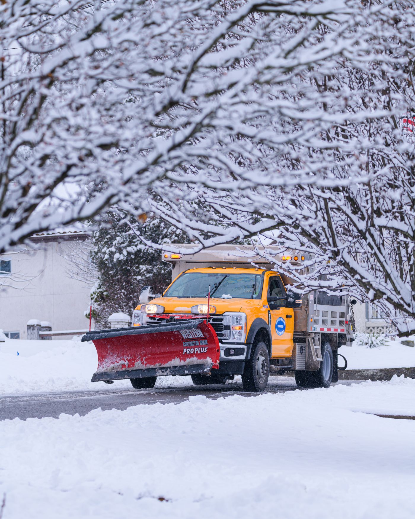Snow plow truck pushing snow at dawn