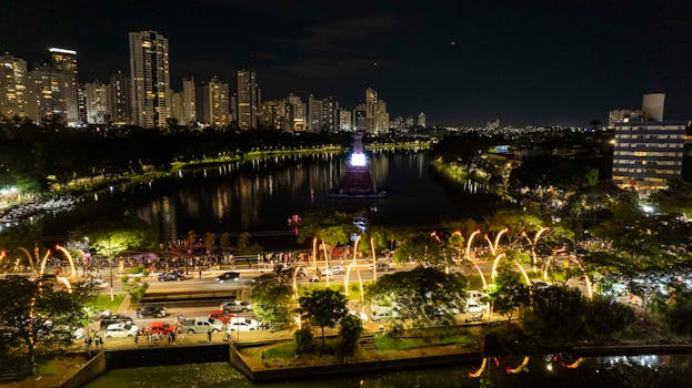 Aerial view of Christmas lights at Lago Igapó, Londrina, Brazil with city skyline.