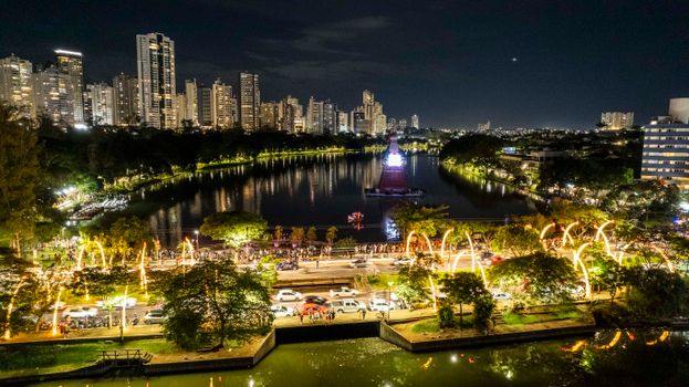 Aerial night view over Lago Igapó with festive Christmas lights in Londrina, Brazil.