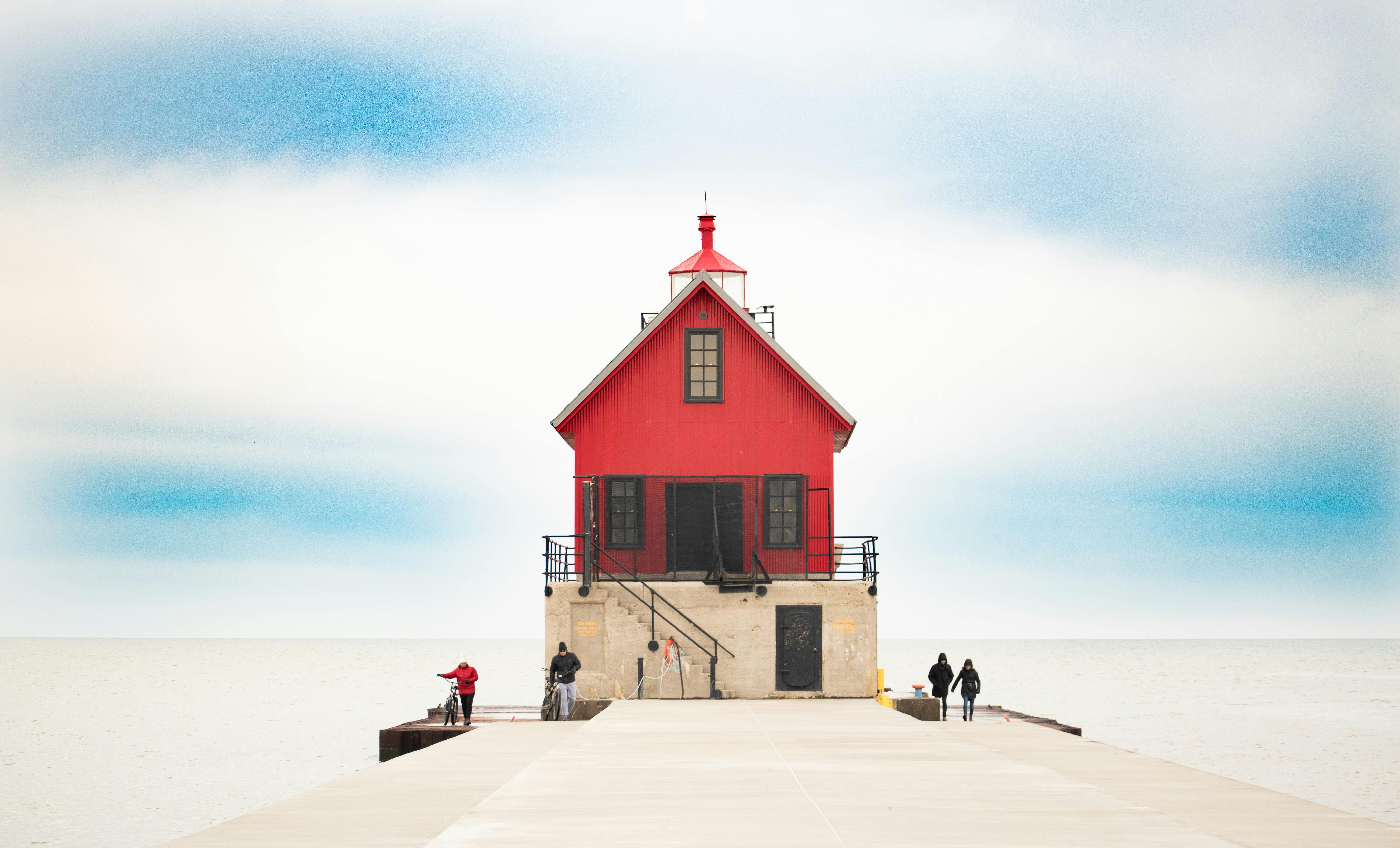 Captivating view of the historic Grand Haven lighthouse against a serene sky on Lake Michigan.