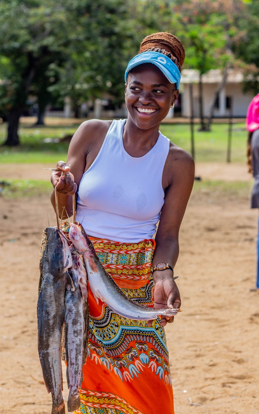Smiling woman holding a fresh catch of fish