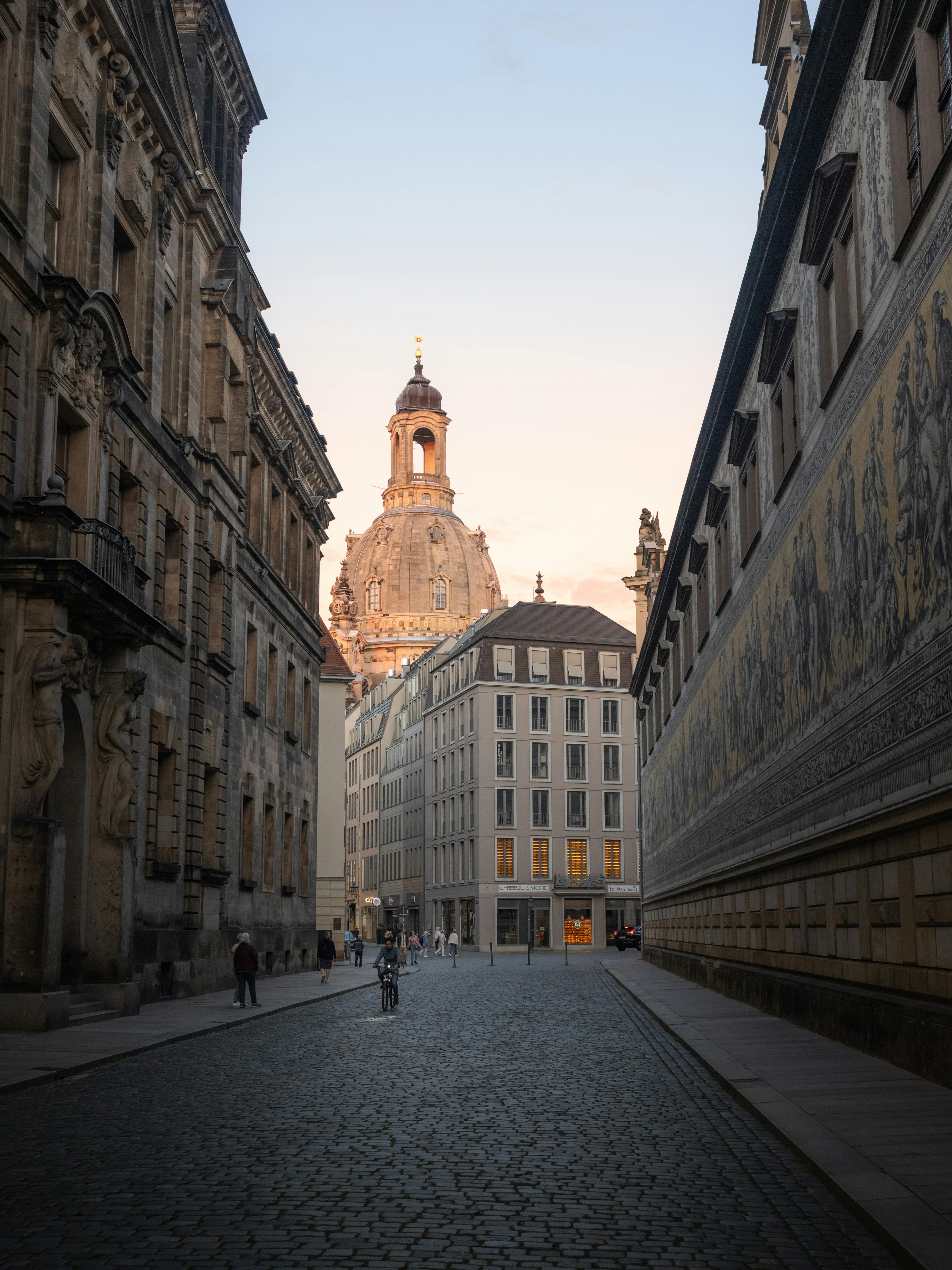 Capture of Dresden's iconic Frauenkirche with surrounding architecture at dusk.