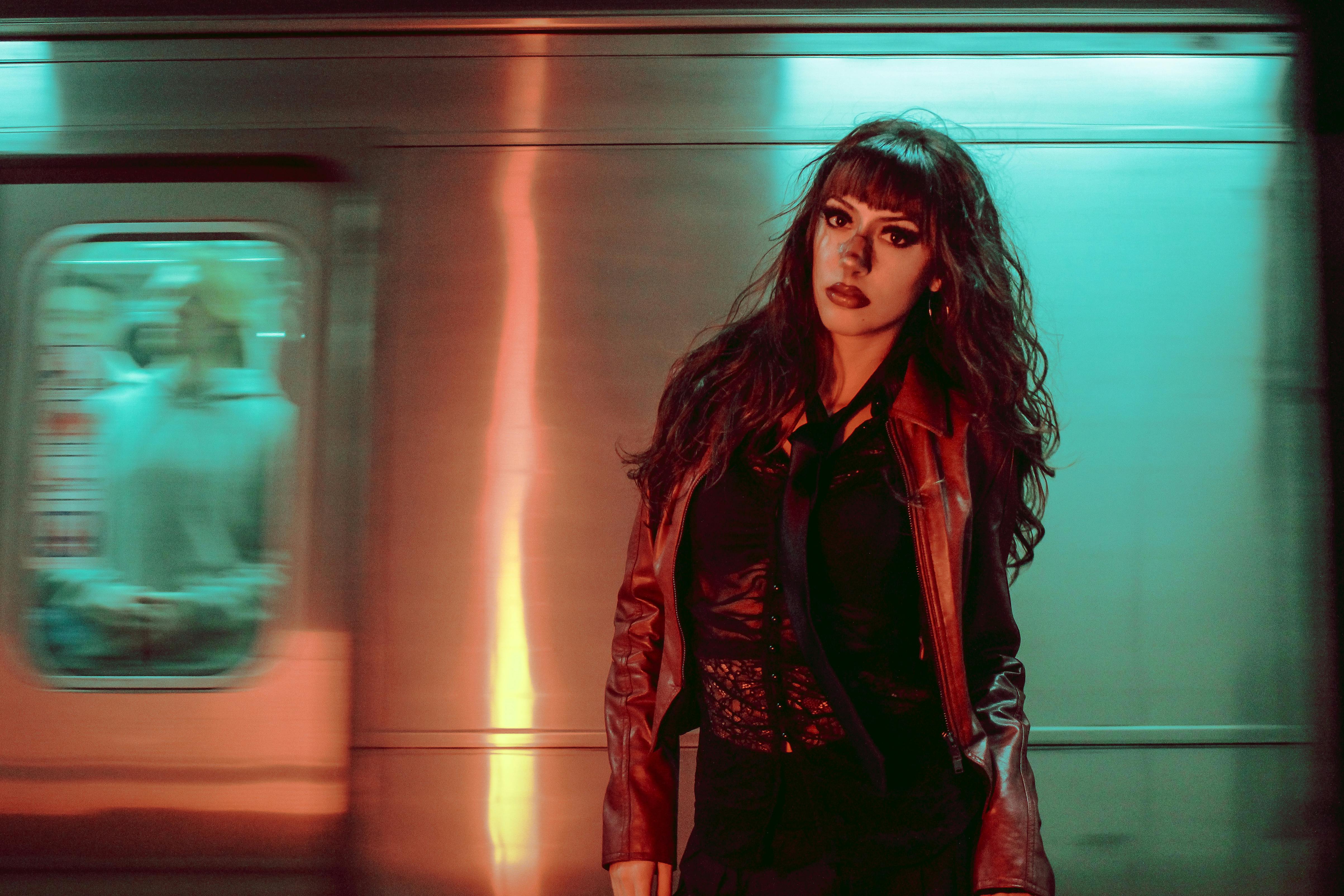 Dynamic portrait of a woman in a subway, blending urban vibrancy with edgy fashion style.