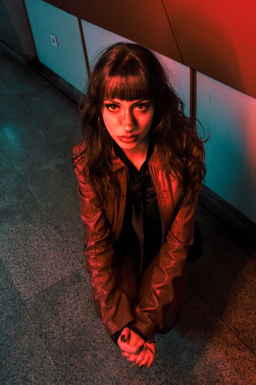 Free Dramatic overhead shot of woman in leather jacket with vivid lighting. Stock Photo