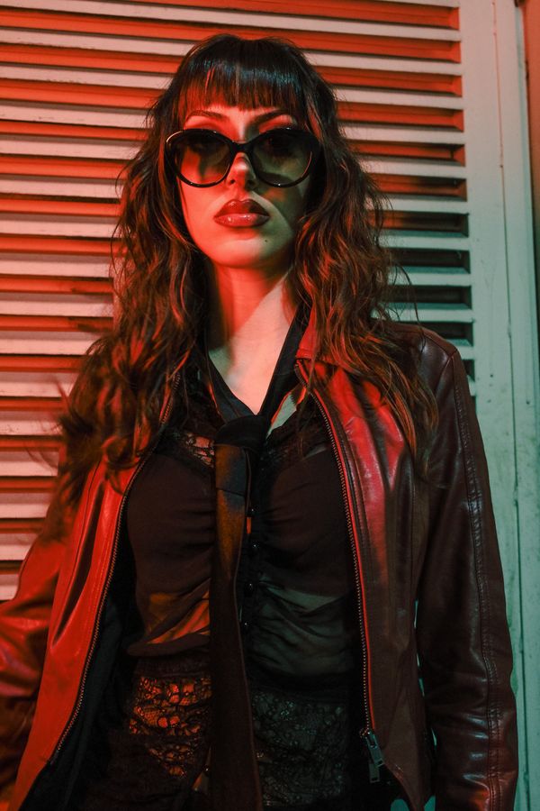 Woman in leather jacket with lace top
