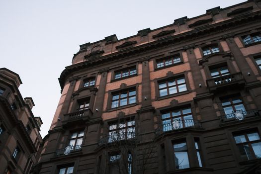 Low angle view of a historic building facade with decorative architecture details in an urban setting.