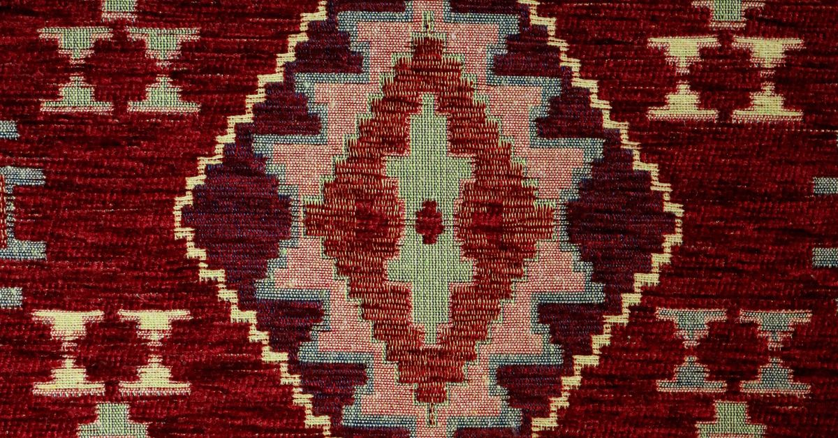 Traditional Geometric Patterned Rug in Warm Tones · Free Stock Photo