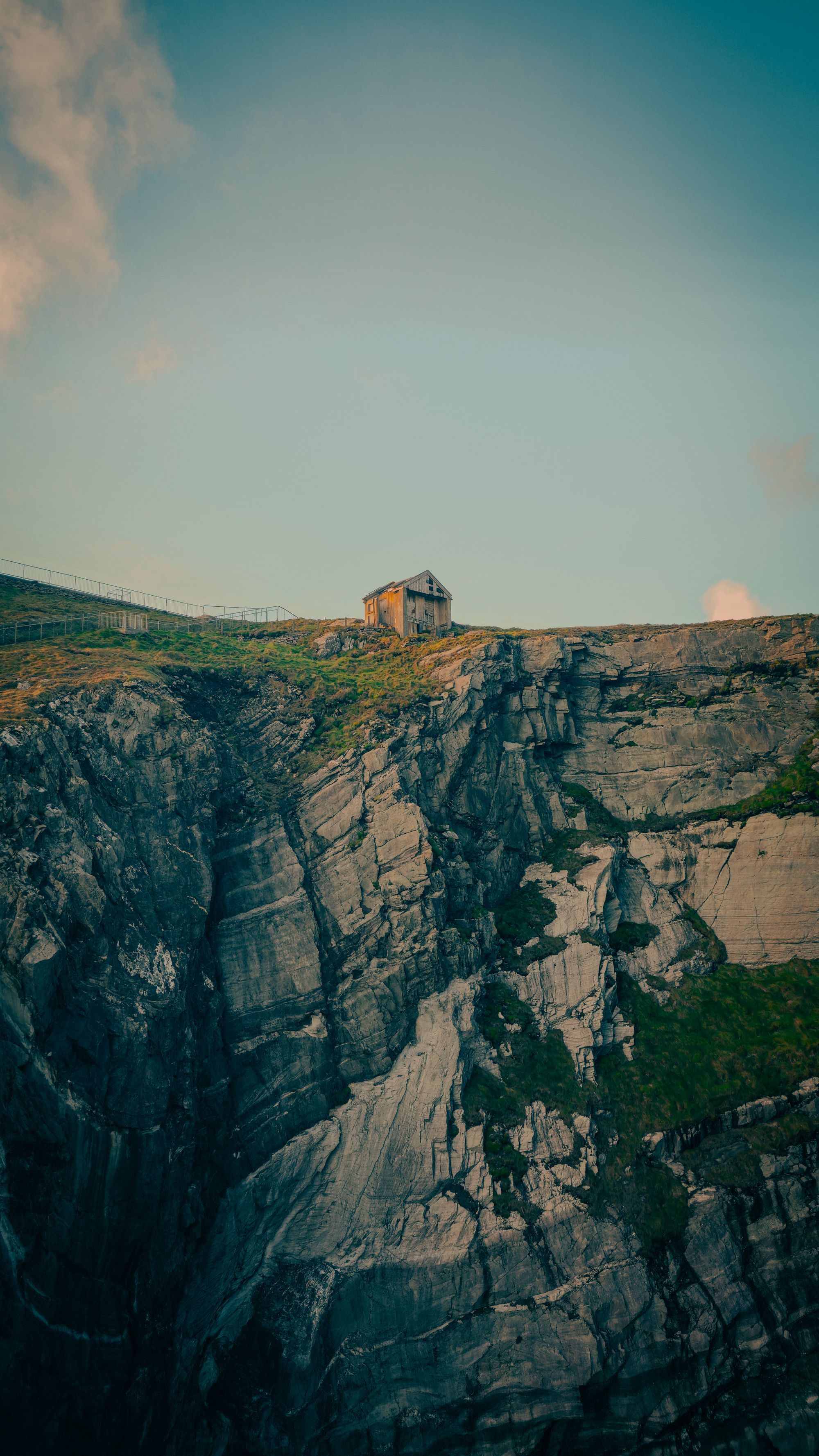 A building on the cliffs of Mizen Head at sunrise