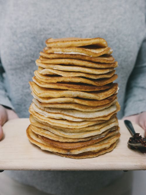 Free Person Holding Board With Pancakes Stock Photo