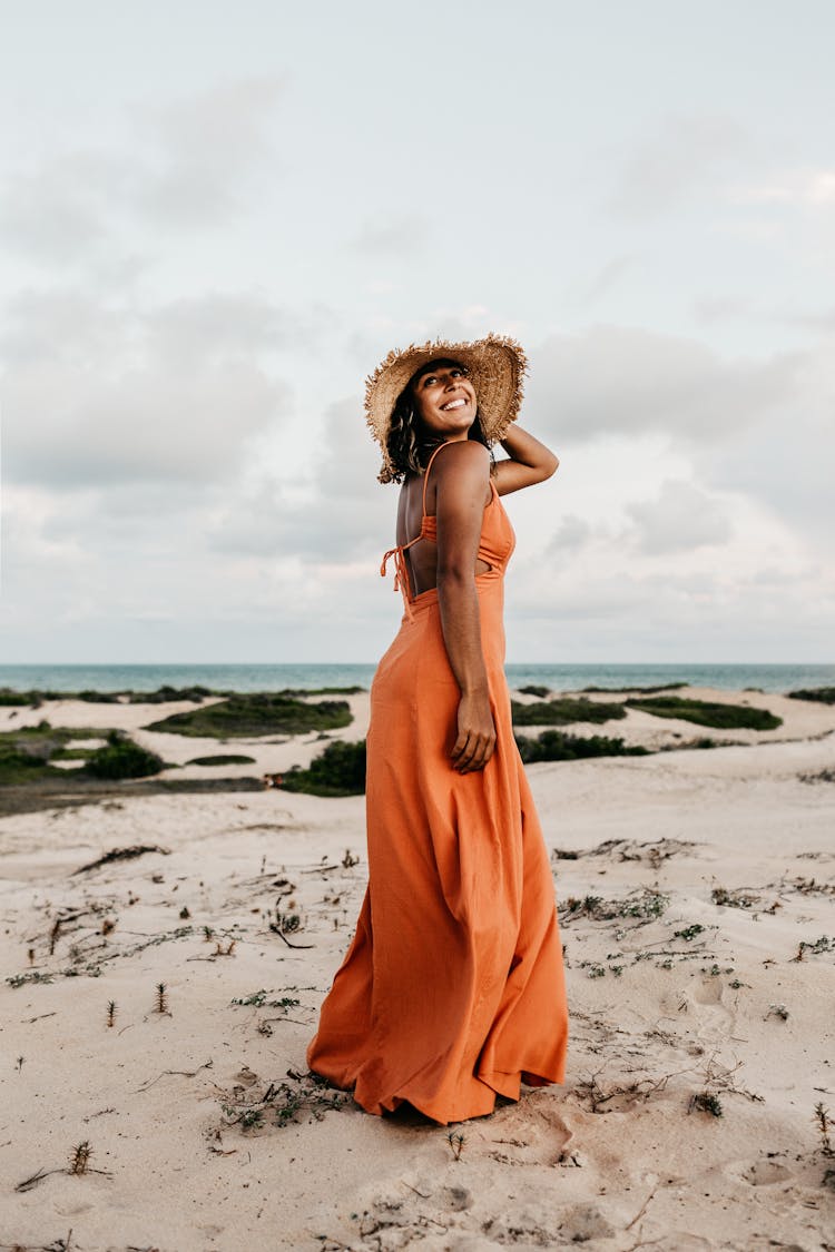 Woman Wearing Orange Dress And Sun Hat