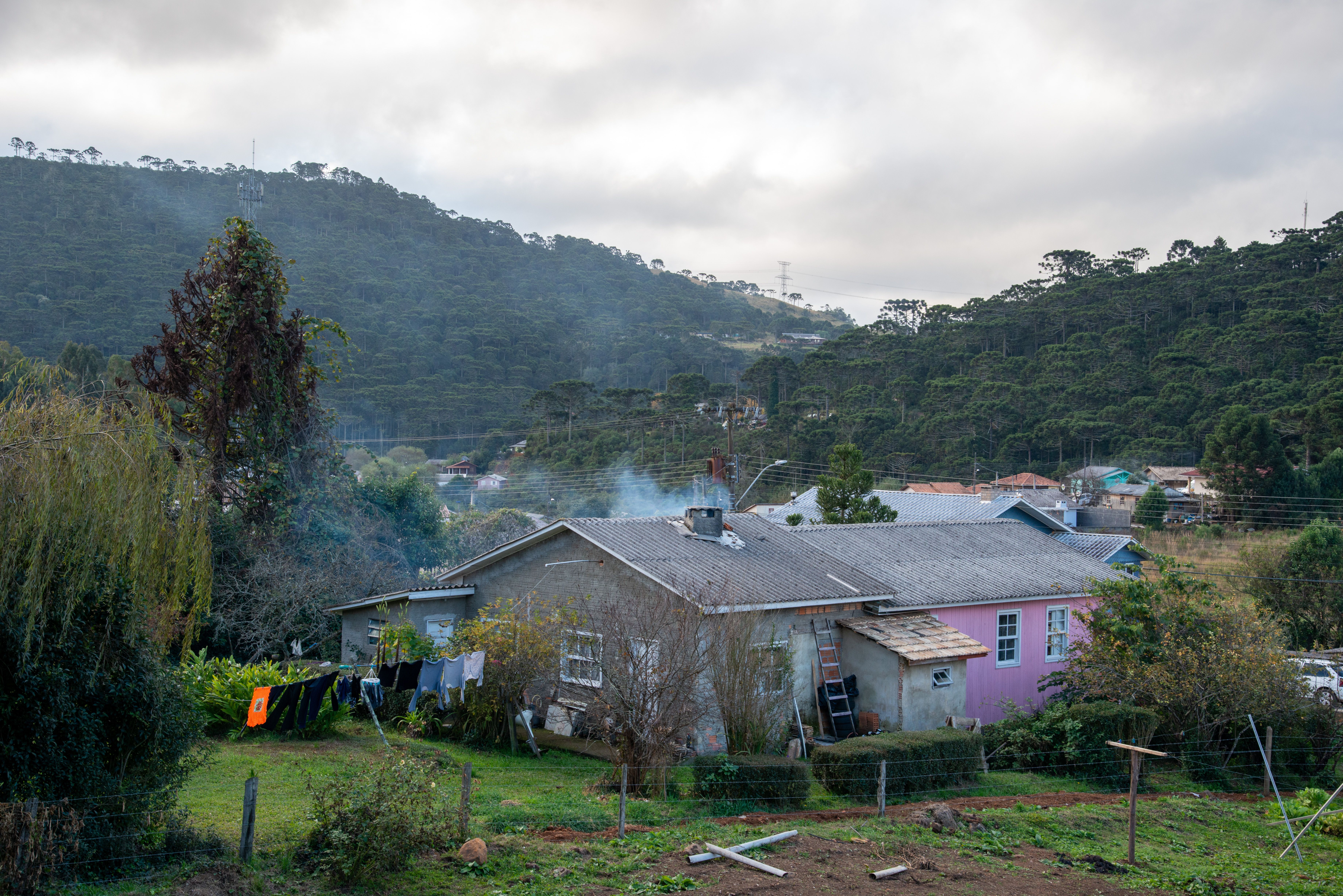 A tranquil rural scene with a house amid lush hills in Bom Jardim da Serra, Brazil.