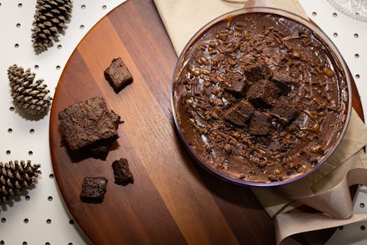 A delicious chocolate dessert with brownie cubes and chocolate shavings.