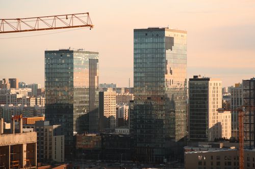 Free Stunning view of glass skyscrapers in Astana with cranes at sunset, showcasing modern architecture. Stock Photo