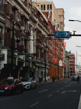 A vibrant city street with historic architecture and traffic, showcasing daily life.