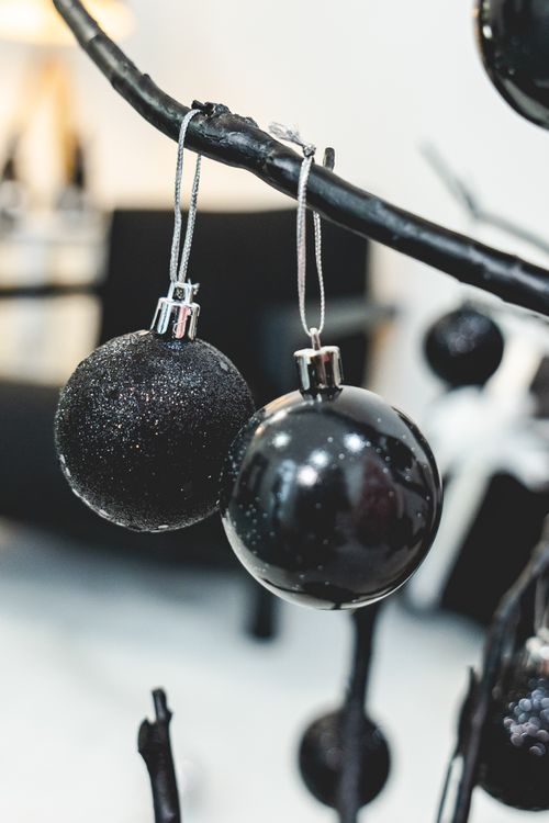 Free Close-up of black Christmas ornaments hanging on a modern branch. Stock Photo
