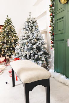 Cozy Christmas room with decorated trees and seat, perfect for holiday celebrations.