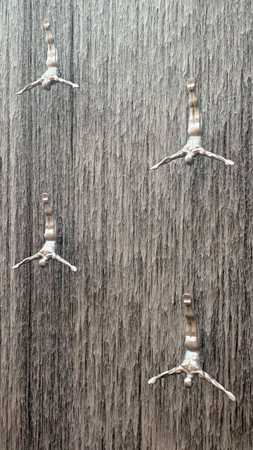 Free Modern sculpture of divers integrated into a waterfall wall, Dubai Mall. Stock Photo