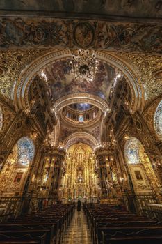 Stunning gold-adorned cathedral interior showcasing intricate architecture and detailed frescoes, capturing historical religious art.
