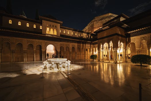 Stunning night view of the Alhambra's Courtyard of the Lions, capturing Moorish architecture.