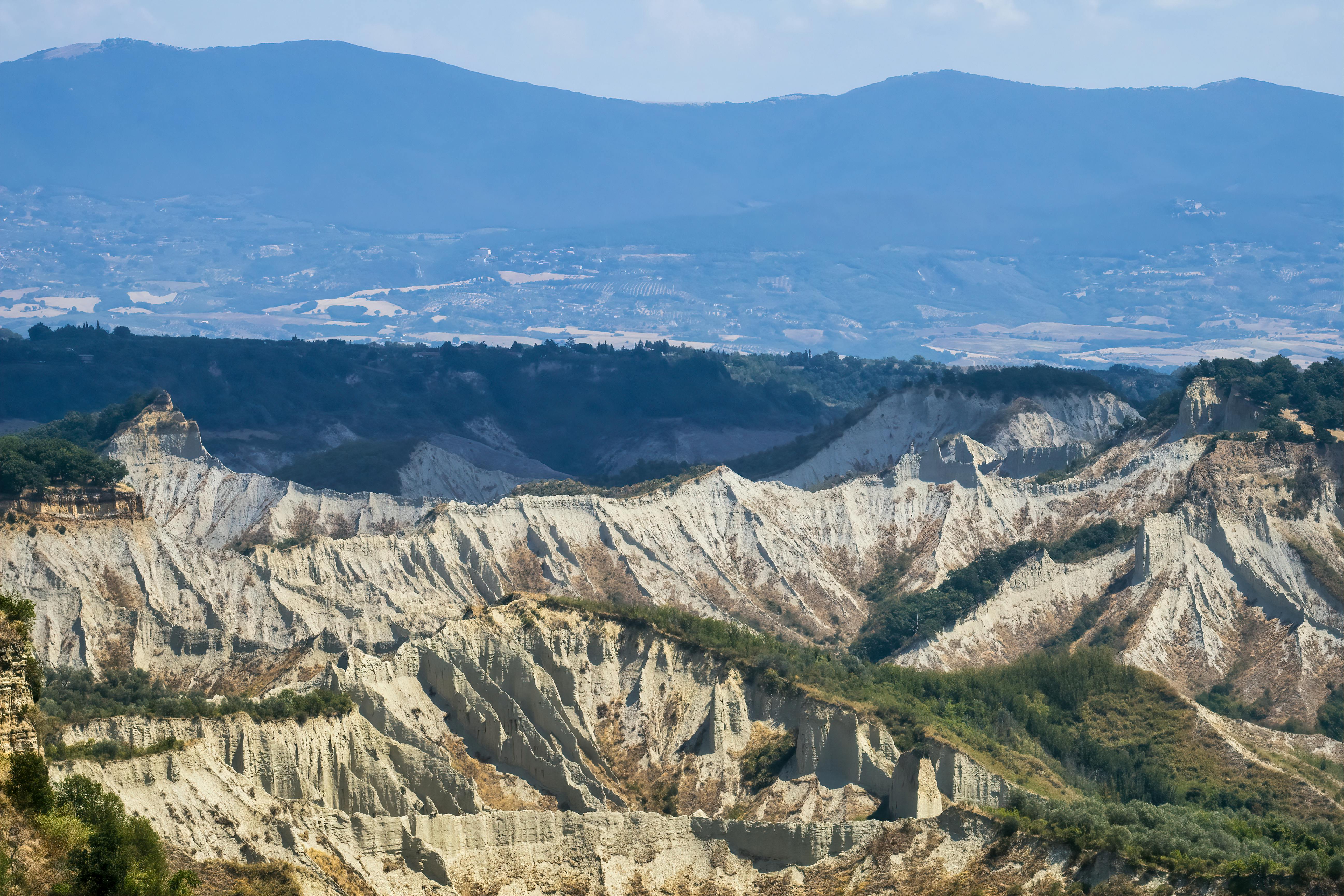 Panoramic landscape of rugged canyon formations under a clear sky, perfect for nature or travel themes.