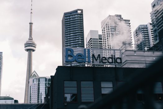 Toronto cityscape with CN Tower and Bell Media building, a blend of modern architecture.