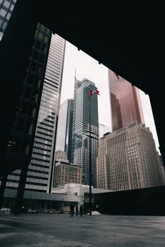 Tall skyscrapers in a cityscape viewed through an architectural frame.