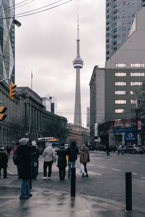 Free A bustling street scene in Toronto with the iconic CN Tower in the background on a winter day. Stock Photo