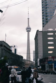 Downtown Toronto street scene with the iconic CN Tower in winter.