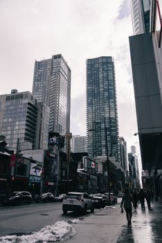 Busy city street with skyscrapers in winter, showcasing urban lifestyle.