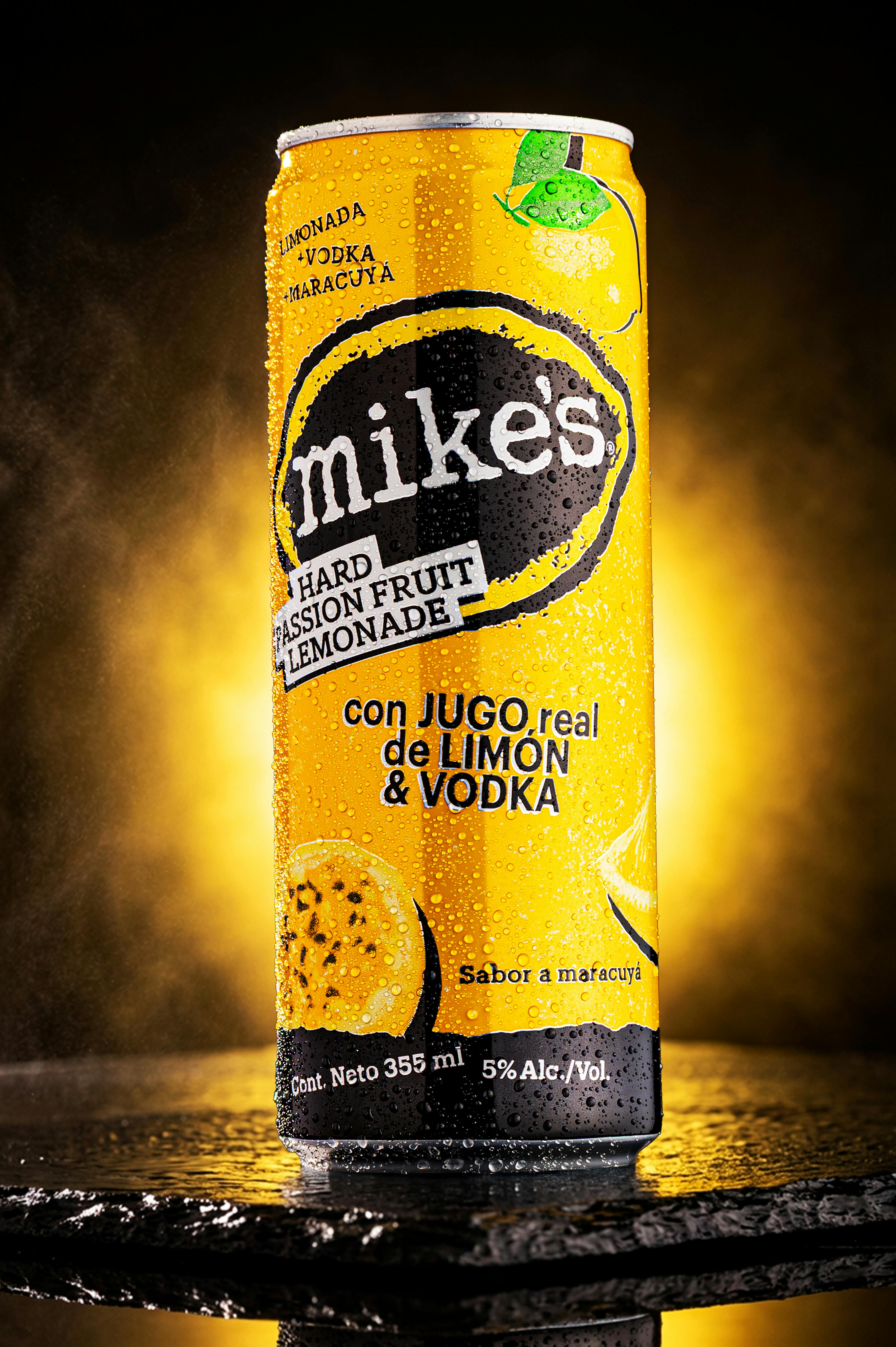 Bright yellow Mike's Hard Passion Fruit Lemonade with lemon and vodka.