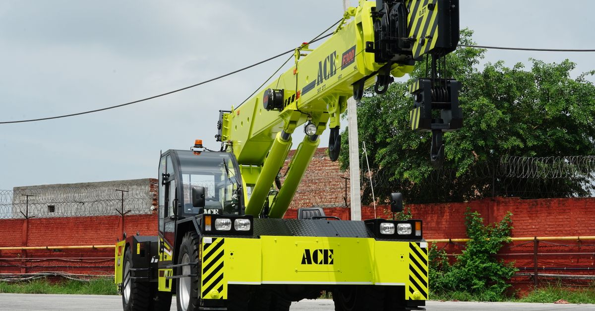 Bright yellow ACE 30 ton mobile crane in Faridabad, India, industrial area.