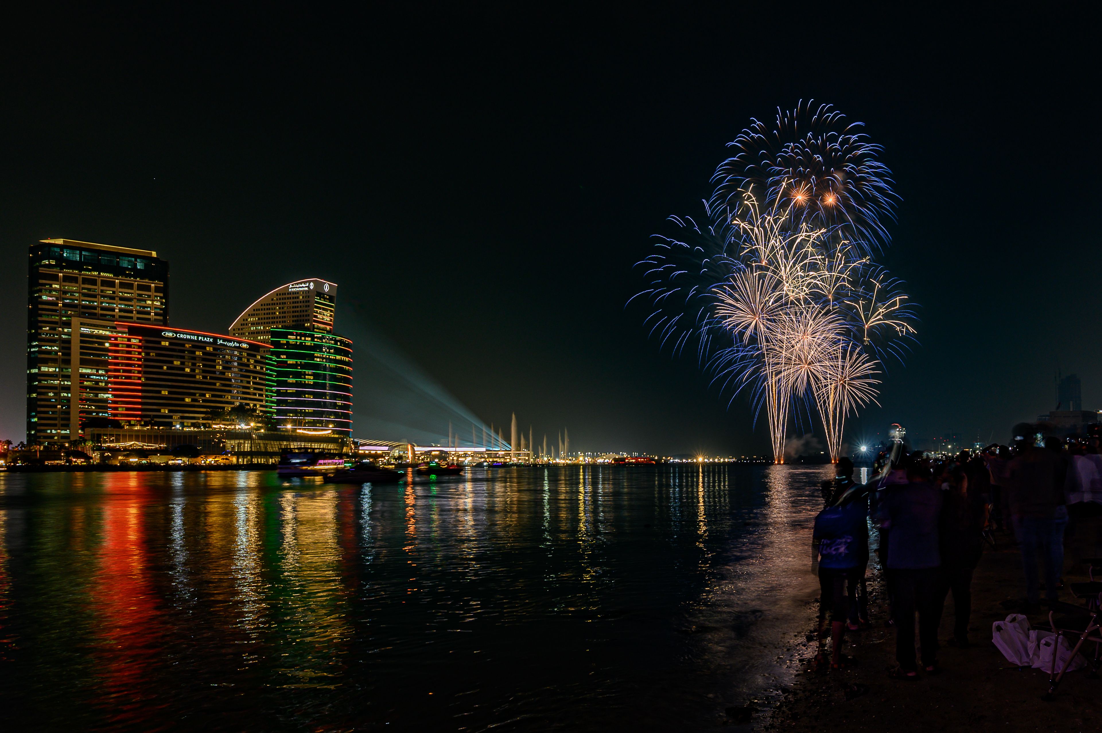 Spectacular Nighttime Fireworks Over City Waterfront · Free Stock Photo