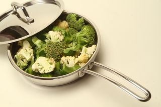Steamed greens in a stainless steel pan with the lid tilted off — photo by Milton Das on Pexels