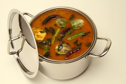 Free Delicious South Indian sambar in a stainless steel pot with vegetables and spices. Stock Photo