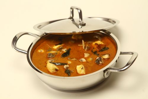 Free A tempting Indian curry served in a shiny stainless steel pot, perfect for food photography and culinary promotions. Stock Photo